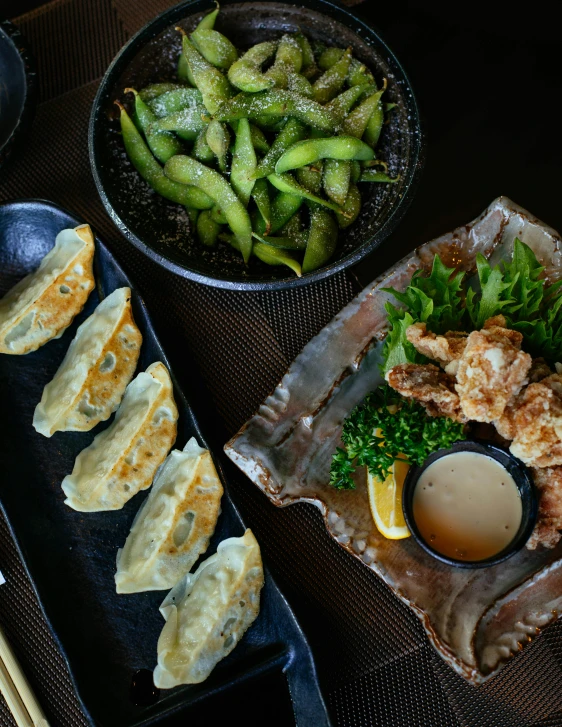a table topped with plates of food and chopsticks, open wings, detailed product image, dessert, green
