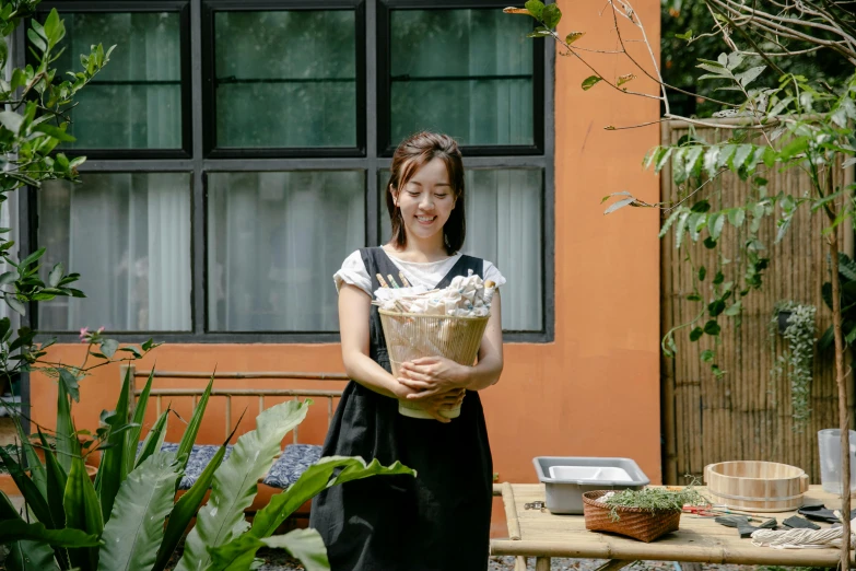 a woman holding a bouquet of flowers in front of a house, inspired by Kim Jeong-hui, pexels contest winner, wearing maid uniform, behind the scenes, serving body, flower shop scene