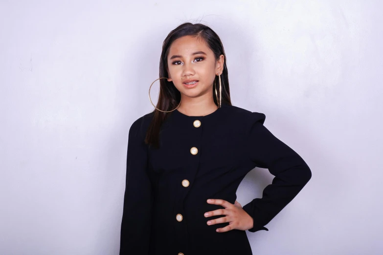 a woman standing with her hands on her hips, an album cover, inspired by Ni Yuanlu, instagram, hurufiyya, wearing a black shirt, headshot profile picture, formal attire, little kid