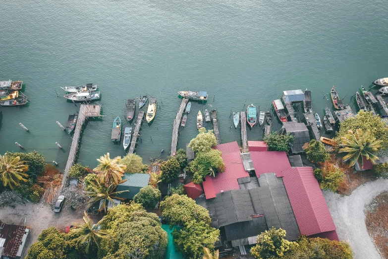 a group of boats sitting on top of a body of water, a screenshot, pexels contest winner, malaysian, new zeeland, inspiring birds eye vista view, small port village