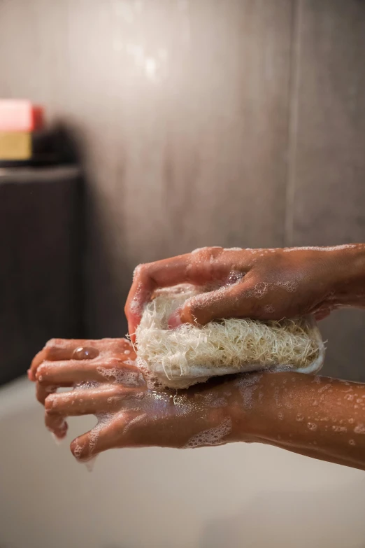 a person washing their hands with soap in a bathroom, by Dan Content, square, spa, dry brushing, hispanic