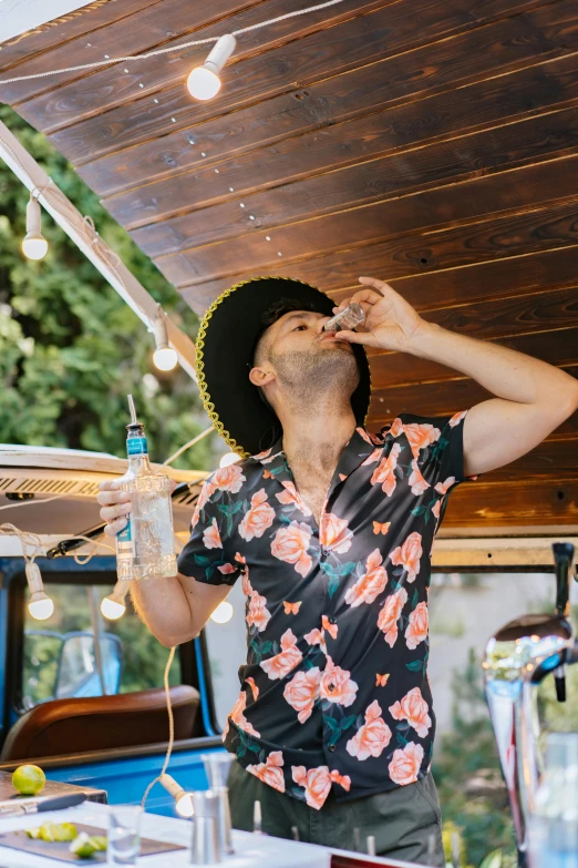 a man that is standing in front of a table, eating ice cream, festival vibes, wearing a cowboy hat, kombi