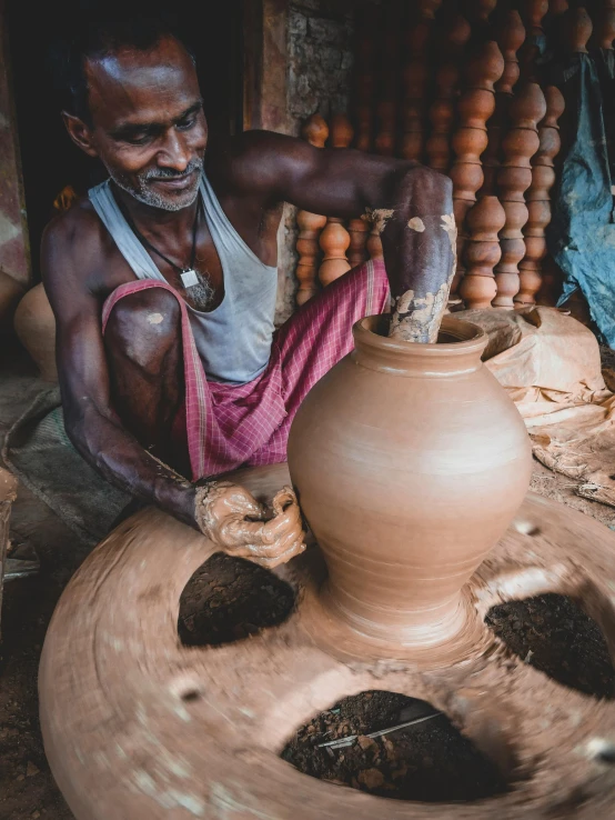 a man is making a pot out of clay, inspired by Steve McCurry, pexels contest winner, kerala motifs, thumbnail, version 3, brown