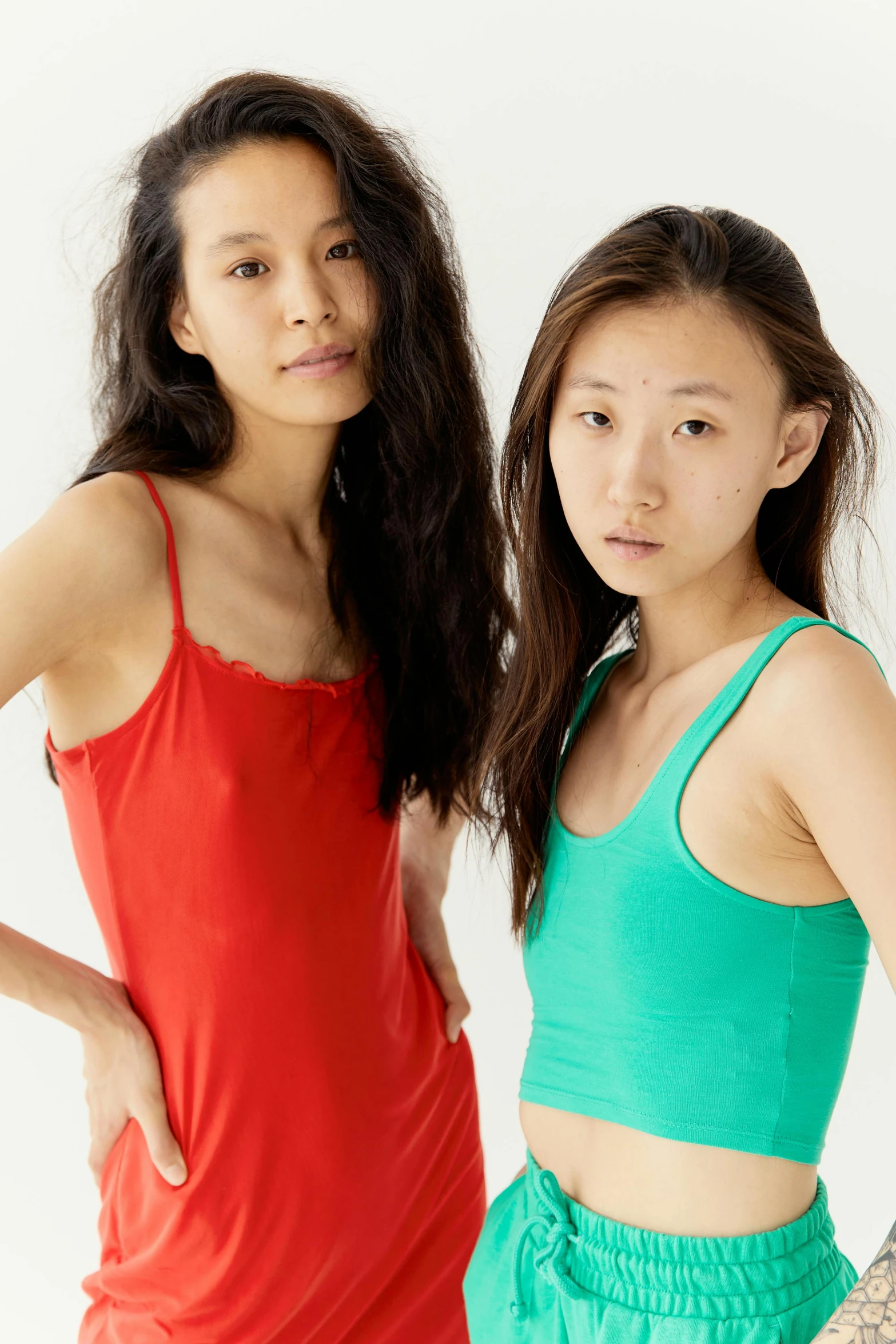 a couple of women standing next to each other, inspired by Ren Hang, trending on unsplash, renaissance, red tank-top, green blue red colors, sleepwear, japanese collection product