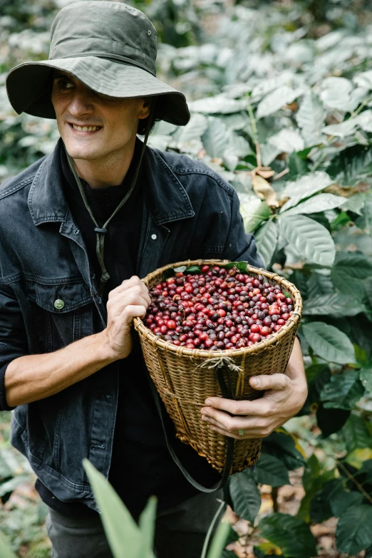 a man holding a basket full of cherries, a portrait, by Jessie Algie, trending on unsplash, coffee beans, in a jungle, avatar image, australia