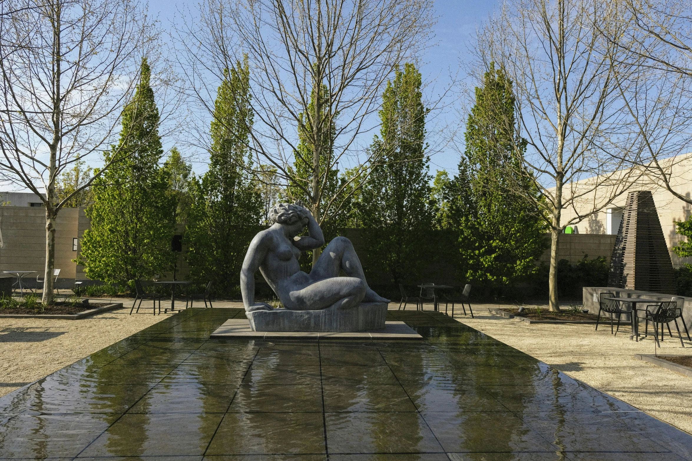 a fountain with a statue in the middle of it, a marble sculpture, by Henry Moore, a wide open courtyard in an epic, persephone in spring, intertwined full body view, mies van der rohe