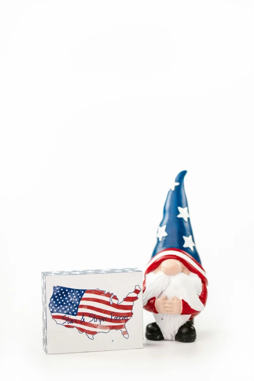 a statue of a gnome holding an american flag, a picture, box, set against a white background, f/15, asleep