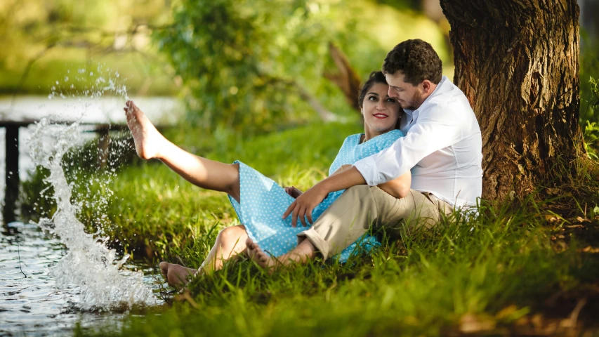 a man and a woman sitting next to a tree, pixabay contest winner, hurufiyya, sitting on green grass, romantic lead, 15081959 21121991 01012000 4k, playful pose