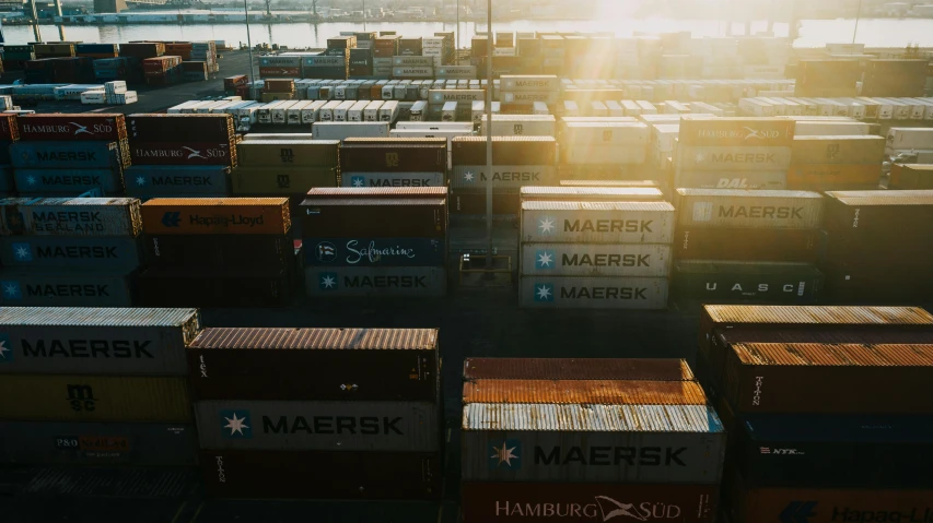 a large group of containers sitting on top of a dock, inspired by Elsa Bleda, unsplash, serine intense sunlight, exterior shot, high quality product image”