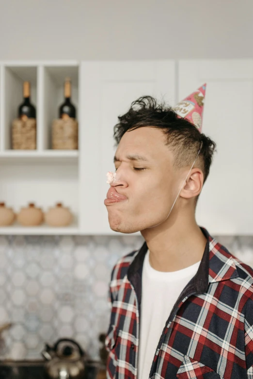 a man standing in a kitchen wearing a party hat, trending on pexels, hyperrealism, licking tongue, gauged ears, gif, asian male
