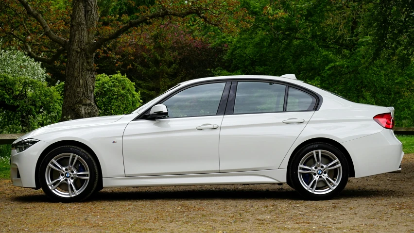 a white bmw car parked on the side of the road, by Tom Bonson, pexels contest winner, s line, side view profile, silver，ivory, f 3 2