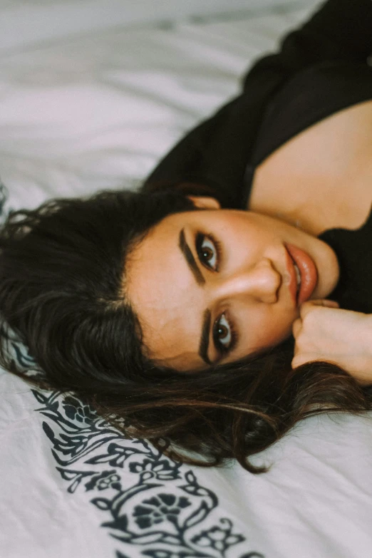 a beautiful young woman laying on top of a bed, trending on pexels, hurufiyya, thick eyebrows, beautiful iranian woman, headshot profile picture, provocative indian