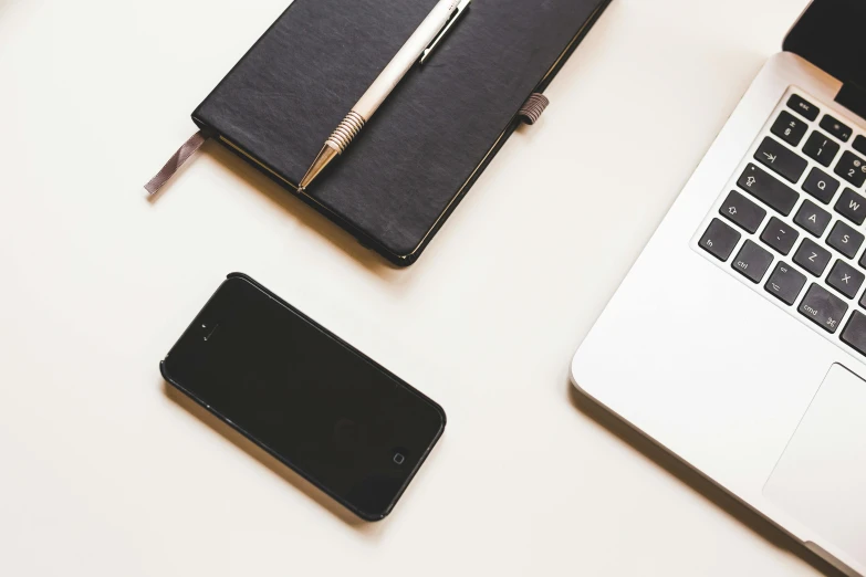 an open laptop computer sitting on top of a desk, by Carey Morris, trending on pexels, minimalism, scanning items with smartphone, fine pen, black, laptops