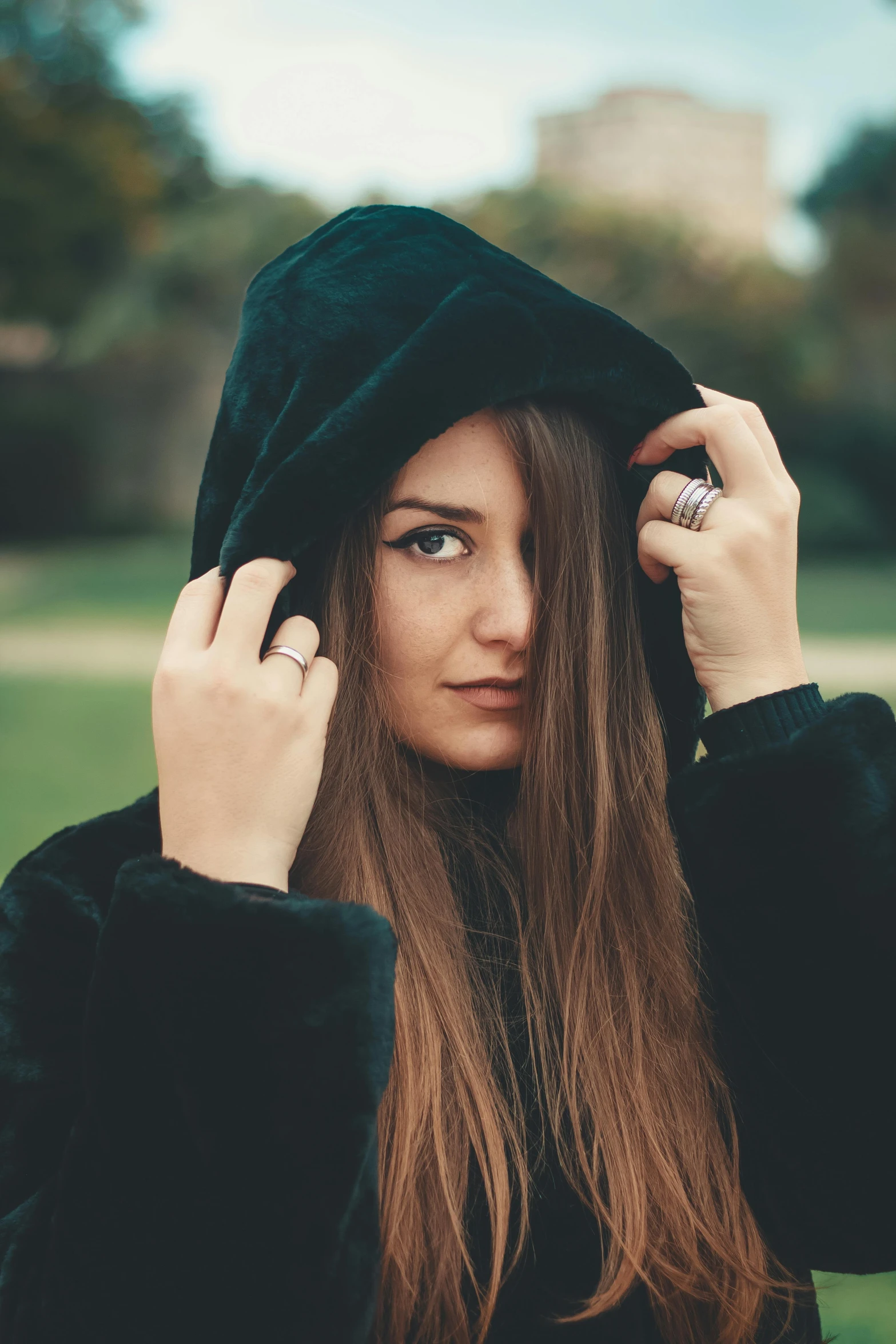 a close up of a person wearing a hoodie, inspired by Elsa Bleda, unsplash, renaissance, silky hair, wearing a fancy black jacket, cute woman, orthodox