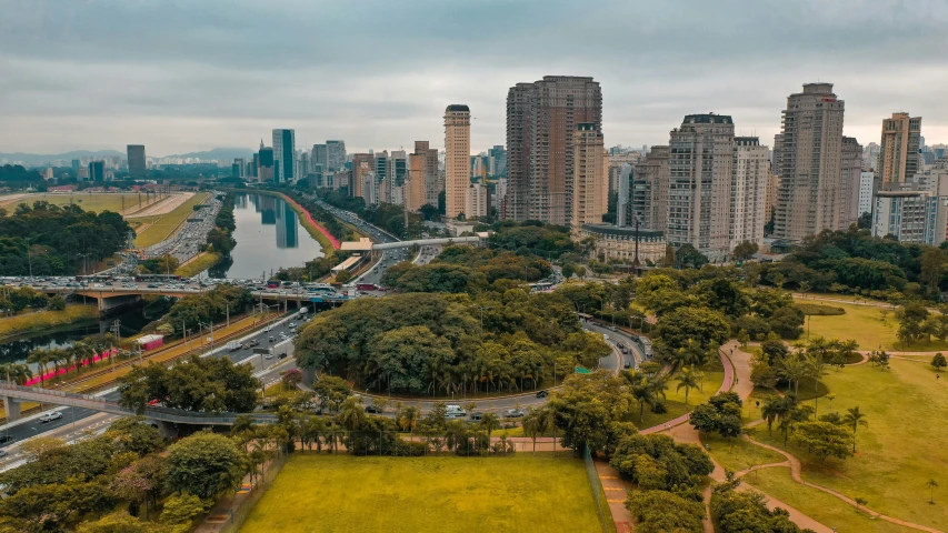 a view of a city from a bird's eye view, by Luis Miranda, pexels contest winner, with a park in the background, brazilian, building along a river, panorama