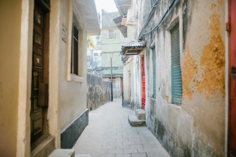 a narrow alley with a red door and windows, an album cover, pexels contest winner, mingei, guwahati, white pale concrete city, video footage, tel aviv street