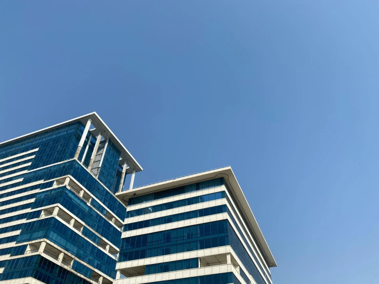 a tall building with a clock on top of it, unsplash, bauhaus, sky blue, medical complex, sprawling, brown