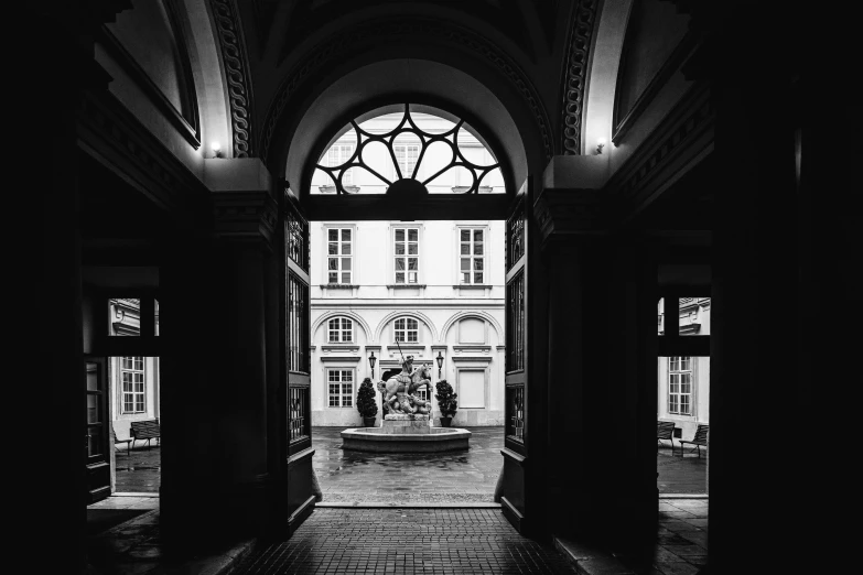 a black and white photo of the entrance to a building, by Kristian Zahrtmann, unsplash contest winner, paris school, courtyard, view from inside, mansion, detmold charles maurice