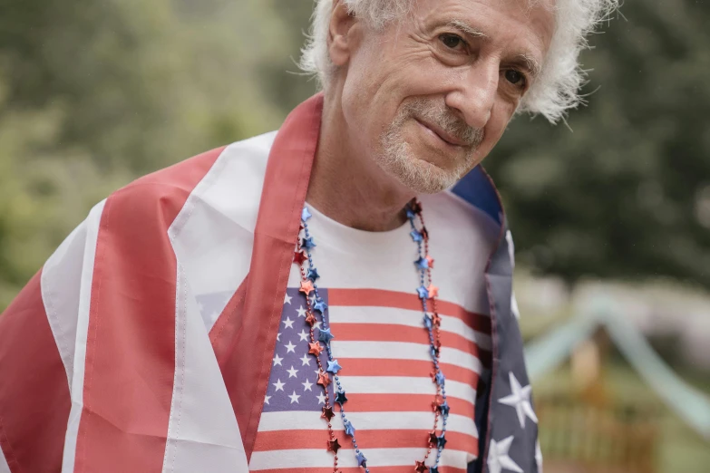 a close up of a person holding an american flag, a colorized photo, inspired by Samuel Dirksz van Hoogstraten, pexels contest winner, curly white hair, al pacino, wearing festive clothing, avatar image