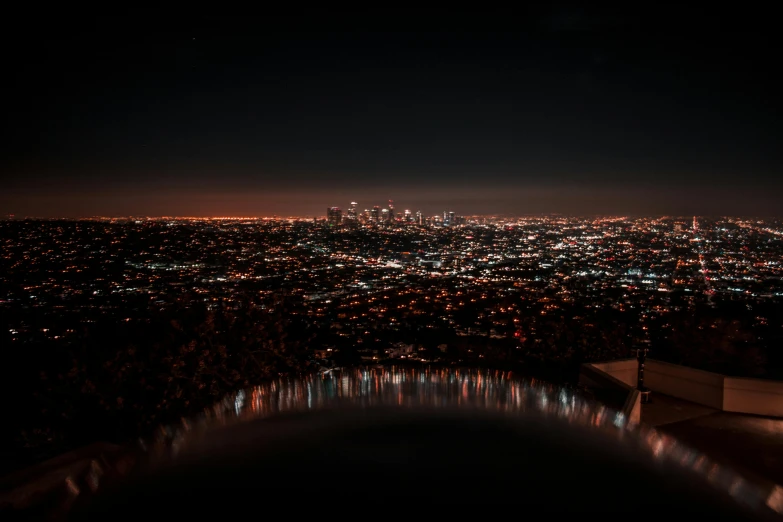 a view of a city at night from the top of a hill, unsplash contest winner, los angeles ca, ☁🌪🌙👩🏾, ultra hd wallpaper, city reflection