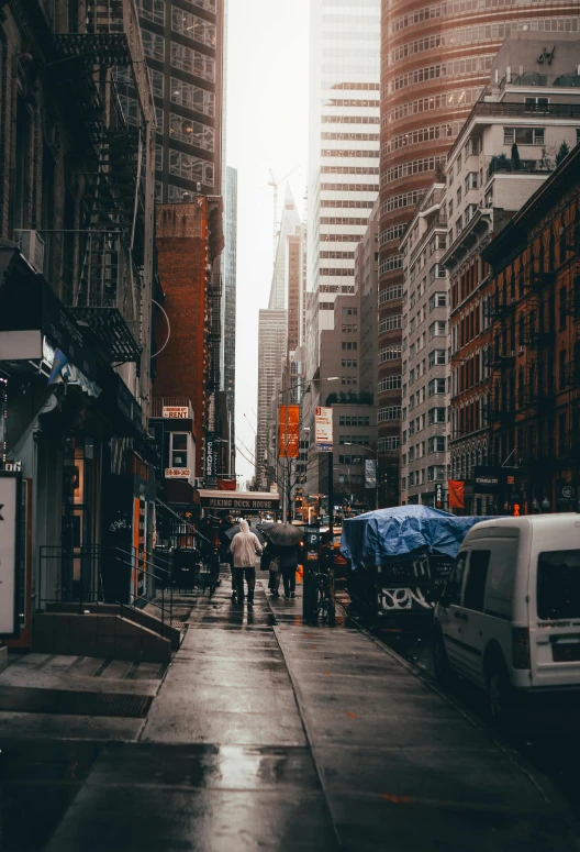 a city street filled with lots of tall buildings, pexels contest winner, new york back street, people with umbrellas, instagram story, dystopian slums