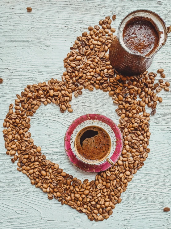 a cup of coffee surrounded by coffee beans, a photo, by Julia Pishtar, pexels contest winner, hearts, background image, made of baked beans, islamic