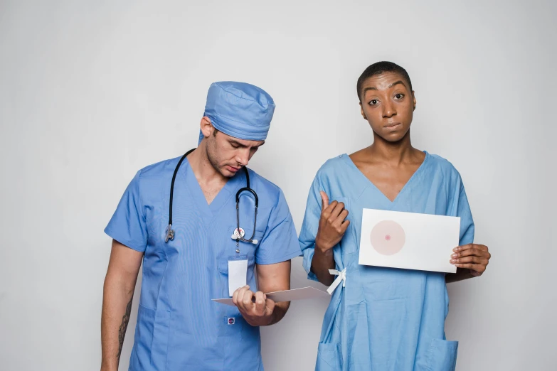 a couple of doctors standing next to each other, a photo, by Matija Jama, pexels contest winner, renaissance, failed cosmetic surgery, brown holes, nurse costume, mix of ethnicities and genders