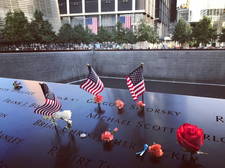 a memorial with american flags and flowers on it, pexels contest winner, instagram picture, manhattan, 3 - piece, instagram post