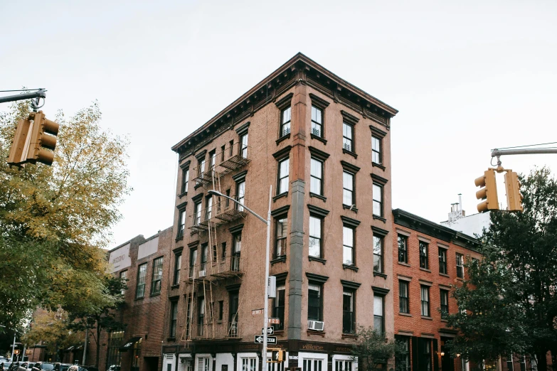 a tall brick building sitting on the corner of a street, pexels contest winner, ashcan school, rundown new york apartment, a quaint, wrought iron architecture, background image