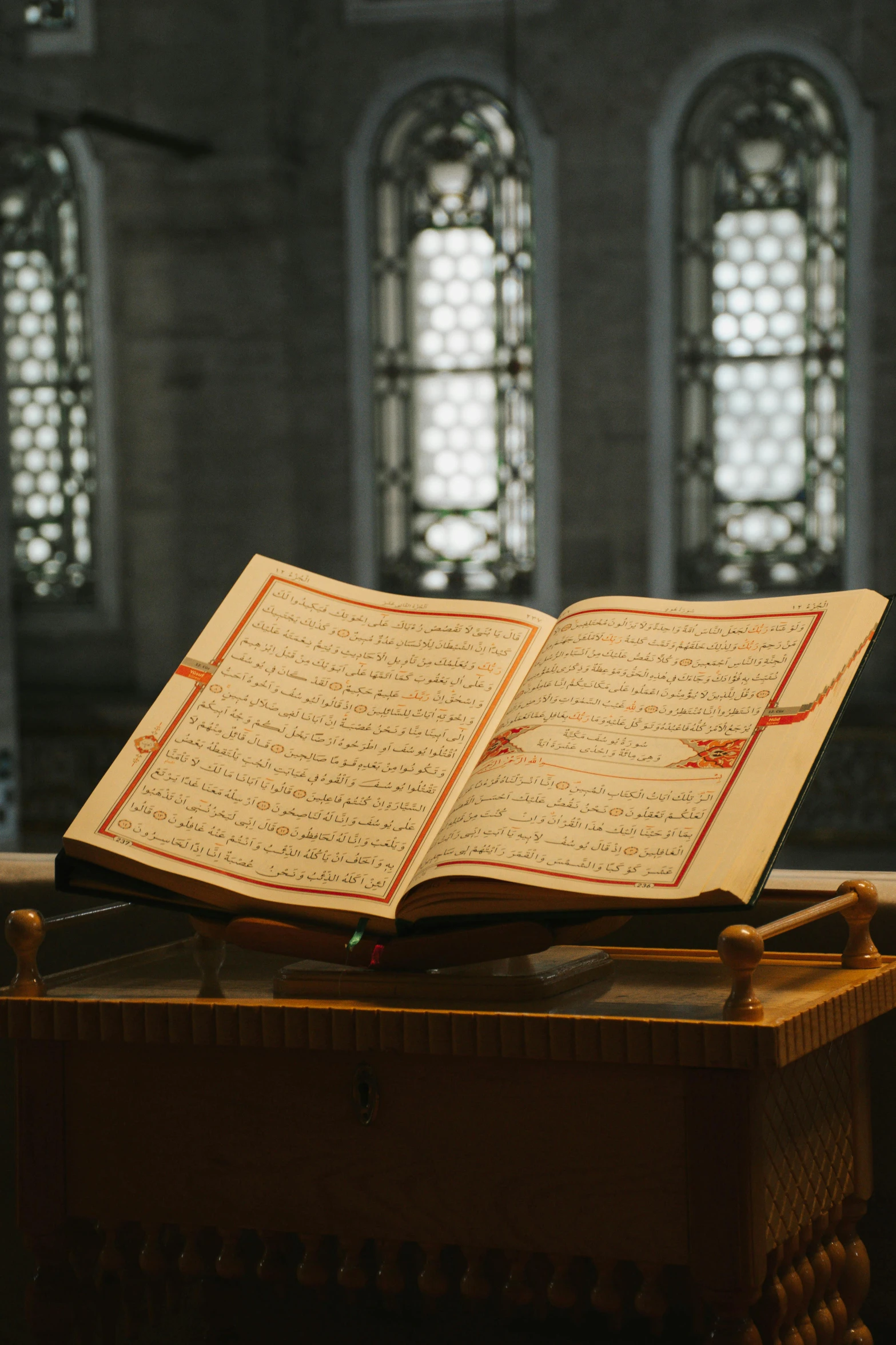 an open book sitting on top of a wooden table, hurufiyya, in front of a carved screen, prayer, thumbnail, tall