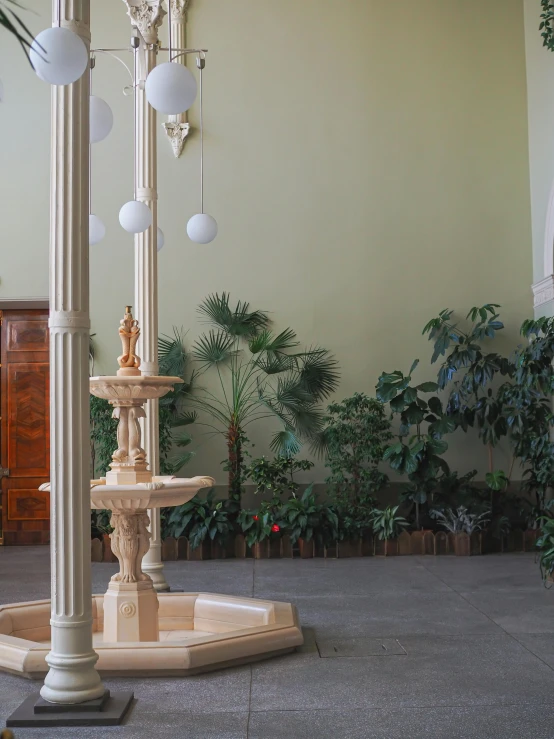 there is a fountain in the middle of the room, inspired by Károly Ferenczy, unsplash, subtropical plants, neo-classicism, in the gallery, scene from church