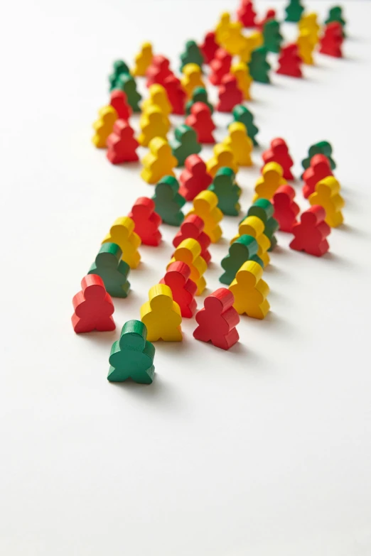 a group of people standing next to each other on a white surface, inspired by Mario Bardi, synthetism, gummy candies, busy crowds, solid coloured shapes, detailed product shot