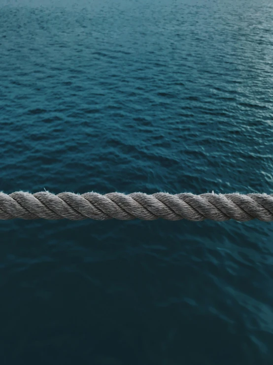 a rope in the middle of a body of water, profile image, navy, medium height, paul barson