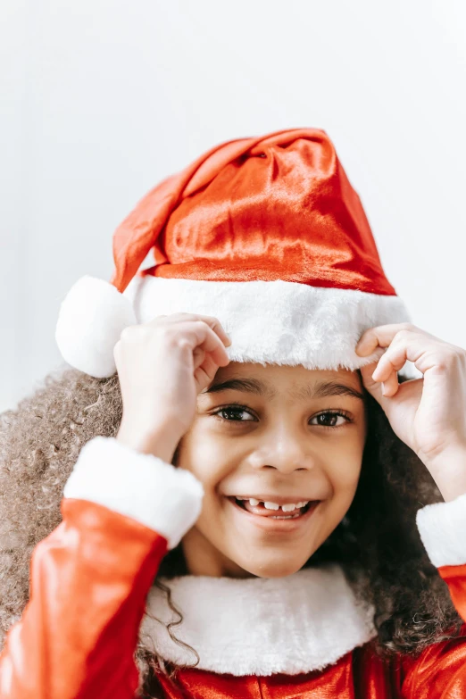 a close up of a child wearing a santa hat, product shot, photo of a black woman, small in size, thumbnail