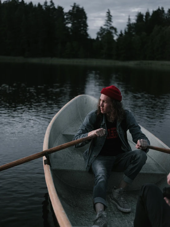 a man and a woman in a boat on a lake, by Christen Dalsgaard, pexels contest winner, he also wears a grey beanie, lil peep, low lighting, movie still frame