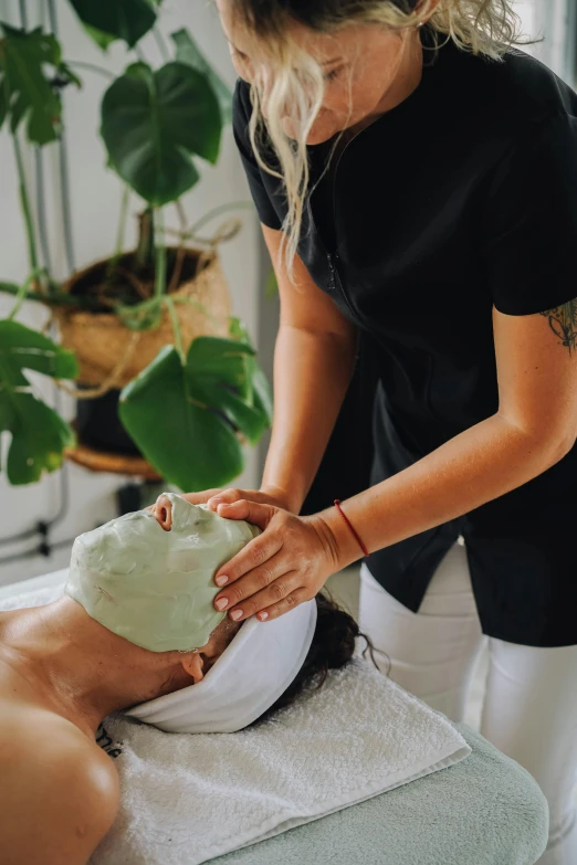 a woman getting a facial mask at a spa, by Lee Loughridge, greenery, manly, cast, lightweight