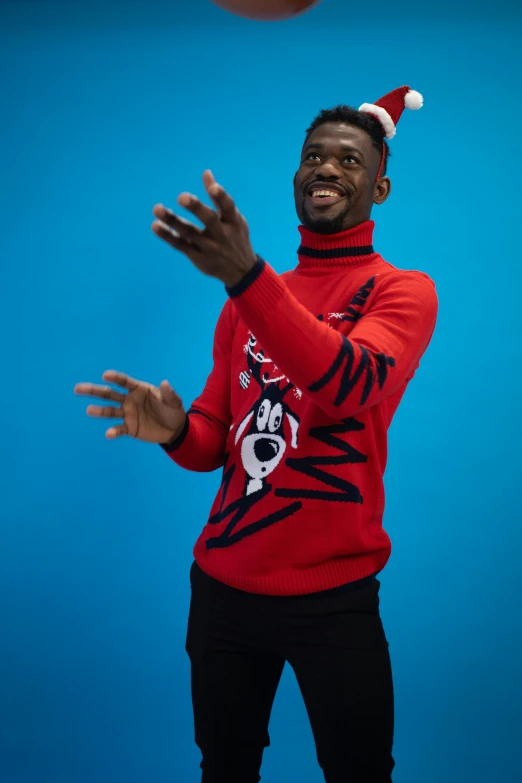 a man in a santa hat throwing a basketball, inspired by Paul Georges, wearing turtleneck, cruella devil, demur, in a navy blue sweater