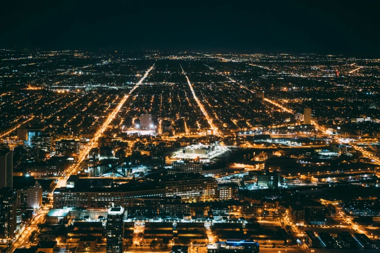 an aerial view of a city at night, pexels contest winner, from wheaton illinois, lit from the side, chicago, high quality image”