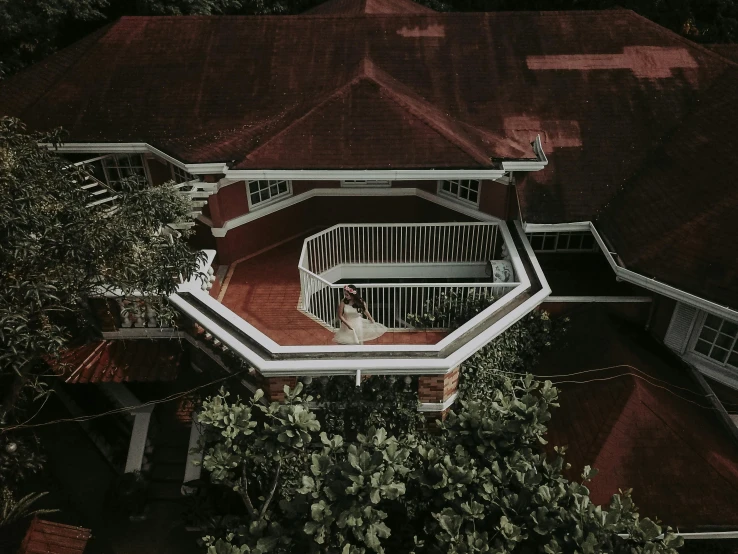 a bird's eye view of a house with a red roof, pexels contest winner, balcony, dark and white, tree house, brown