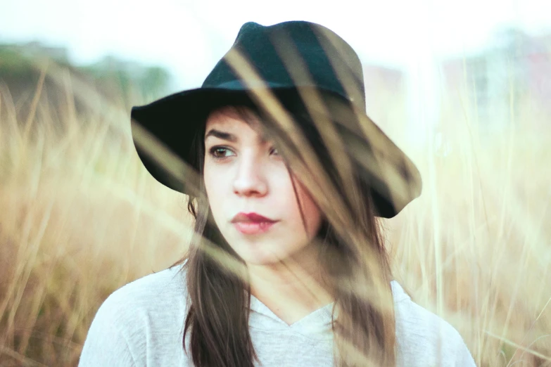 a close up of a person wearing a hat, inspired by Elsa Bleda, pexels contest winner, girl with dark brown hair, singer songwriter, flat colour, straw