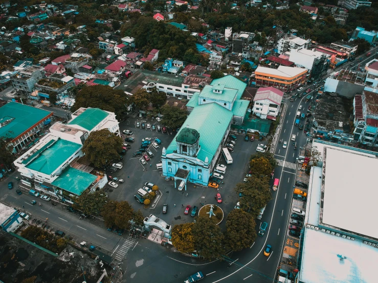 an aerial view of a city with lots of buildings, by Marshall Arisman, pexels contest winner, visual art, 1970s philippines, square, cyan, beautiful small town