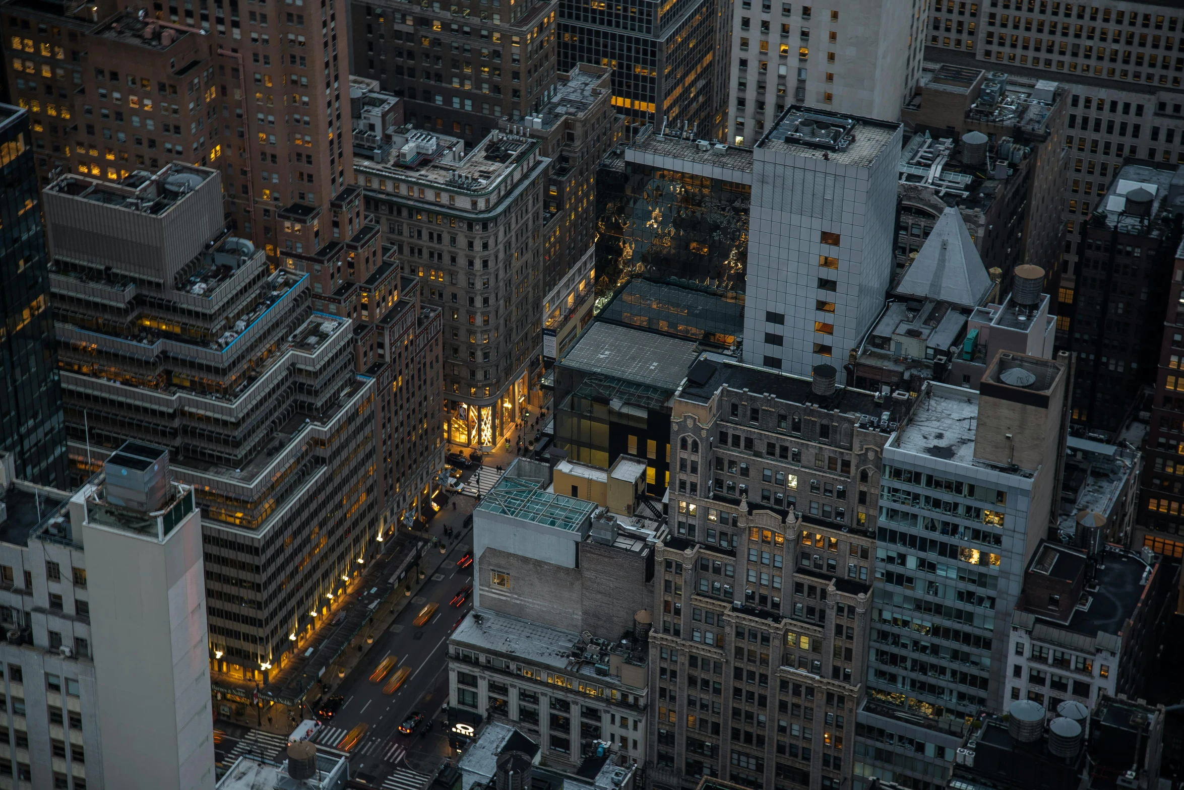 a view of a city from the top of a building, by Adam Rex, pexels contest winner, new york streets, late evening, hyperdetailed, small buildings