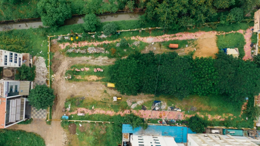 an aerial view of a house being built, by Adam Marczyński, land art, panorama of crooked ancient city, profile image, green spaces, brown