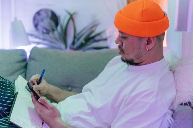 a man in an orange hat sitting on a couch, a drawing, pexels contest winner, asian male, post malone, took on ipad, sharpie