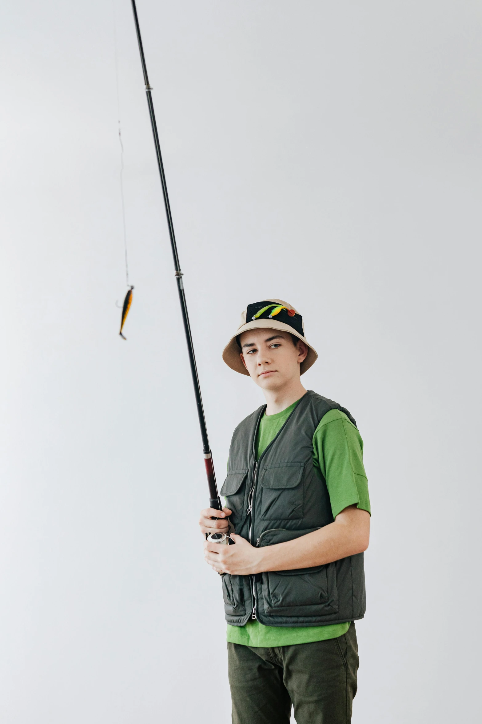 a boy in a hat is holding a fishing rod, by Tobias Stimmer, model is wearing techtical vest, yanjun chengt, 1 6 years old, large)}]