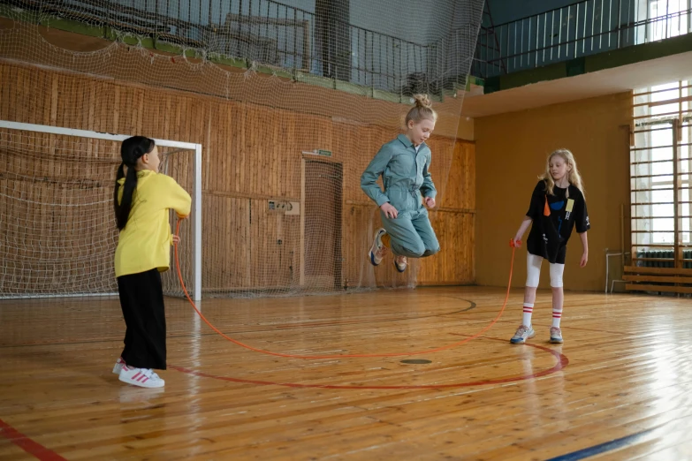 a group of young girls playing a game of frisbee, pexels contest winner, danube school, full body 8k, ropes, indoor, thumbnail