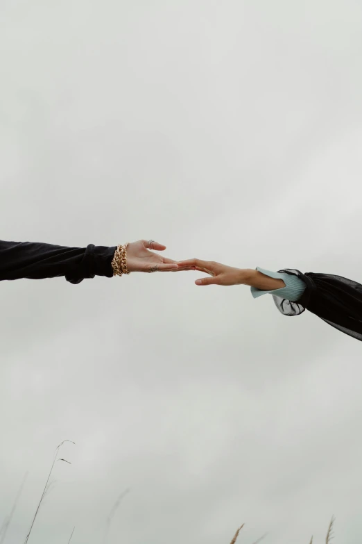 a man and a woman holding hands in a field, an album cover, unsplash, on a gray background, reaching out to each other, mechanics, 15081959 21121991 01012000 4k