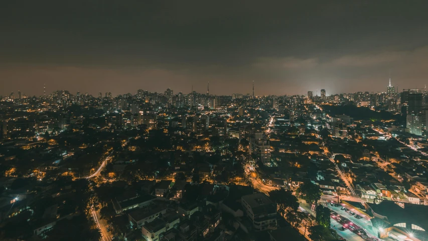 an aerial view of a city at night, pexels contest winner, gloomy lighting, manila, night time footage, sao paulo