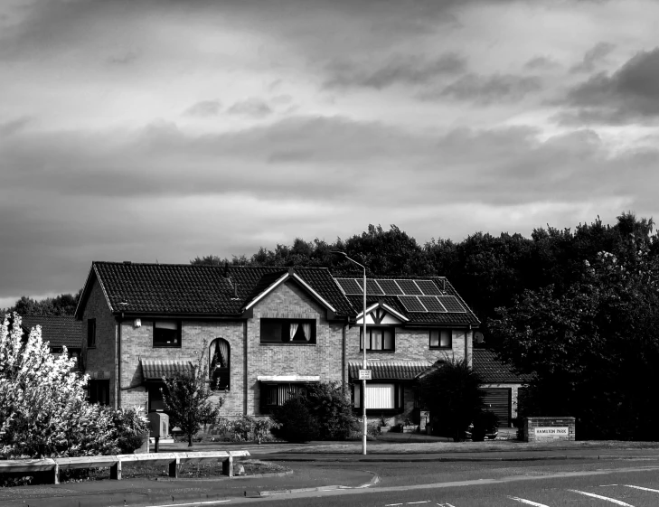 a black and white photo of a house, by Dave Allsop, pixabay, houses and roads, solar, glasgow, suburban home