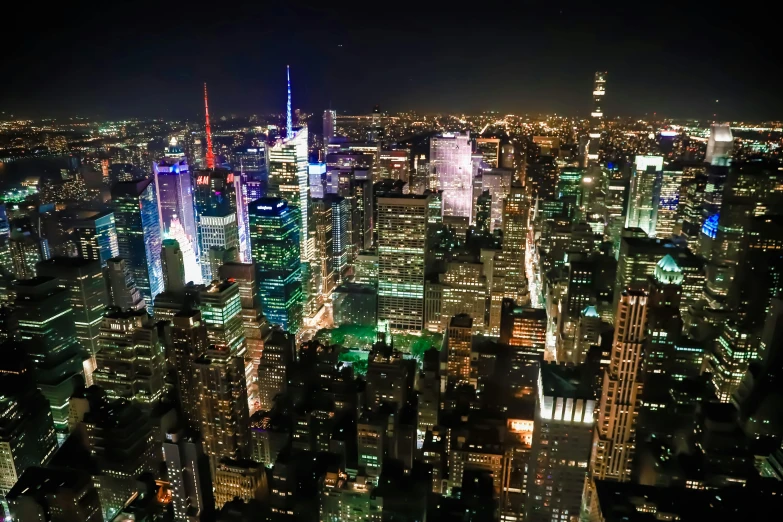 a view of a city at night from the top of a building, empire state building, slide show, multicoloured, high-resolution